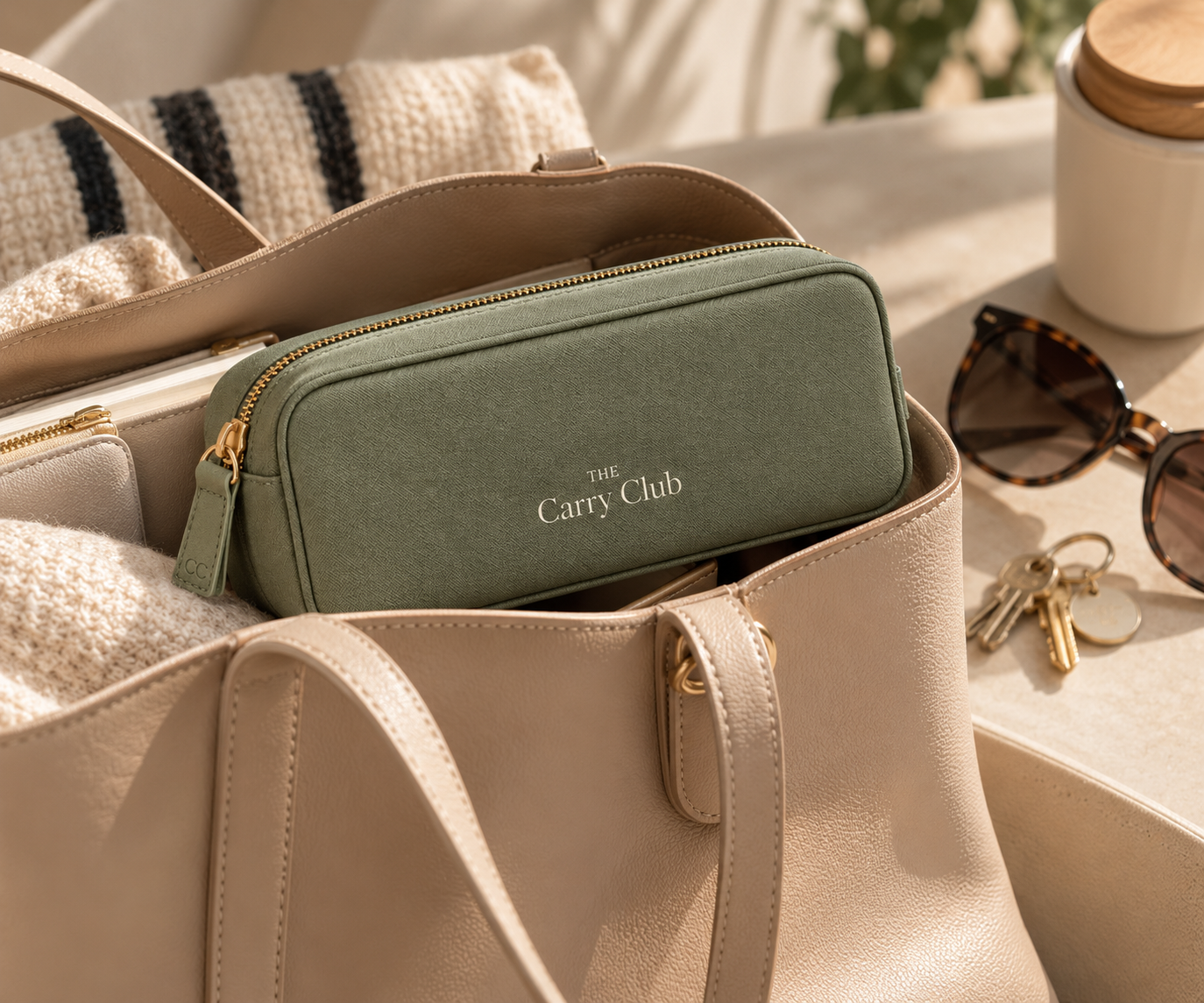The Carry Club Sage Everyday Organiser inside a beige leather tote bag with everyday accessories